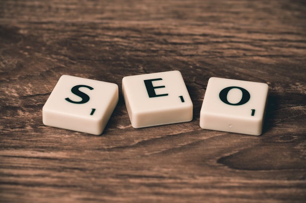 pexels photo 270637 Scrabble tiles spelling 'SEO' on a wooden surface. Ideal for digital marketing themes.
